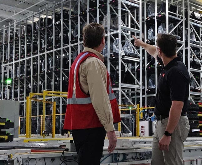 consultant with operation manager in automated warehouse